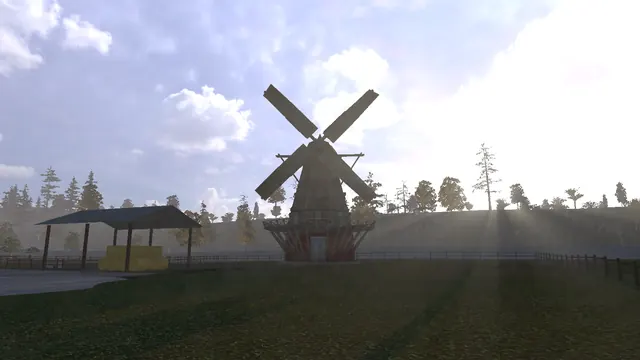 Sunrise at the farm. The mill's sails turn with the wind.
